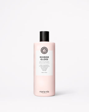 A bottle of Maria Nila Mirror Gloss Shampoo in a pale pink bottle with a black cap and white label, centered on a light gray background.