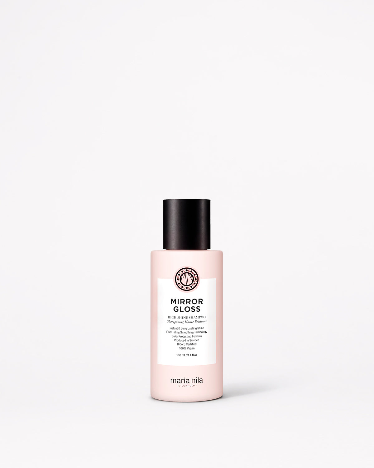 A bottle of Maria Nila Mirror Gloss Shampoo in a pale pink bottle with a black cap and white label, centered on a light gray background.